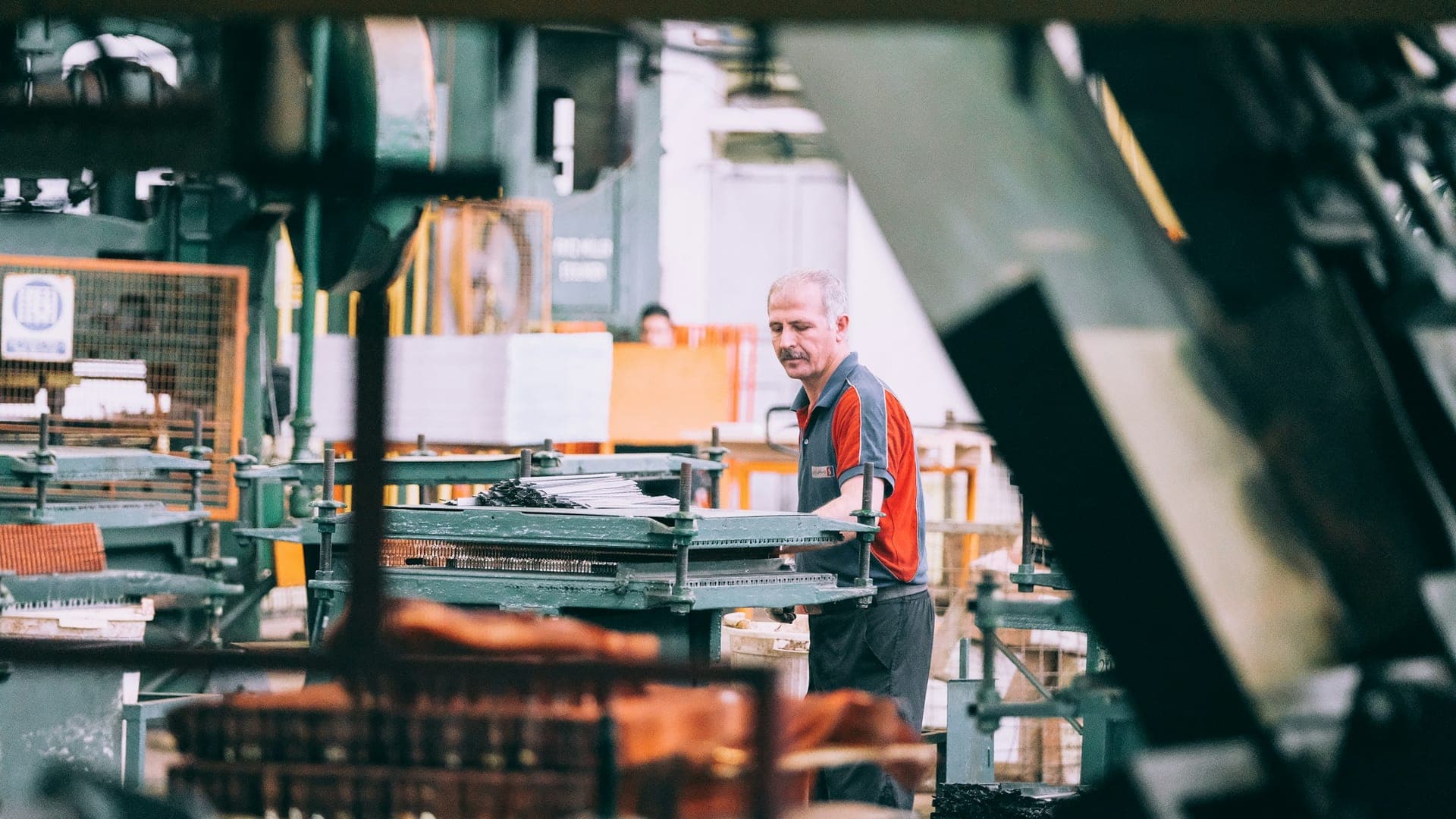 An operator at work among machine tools in a machining shop